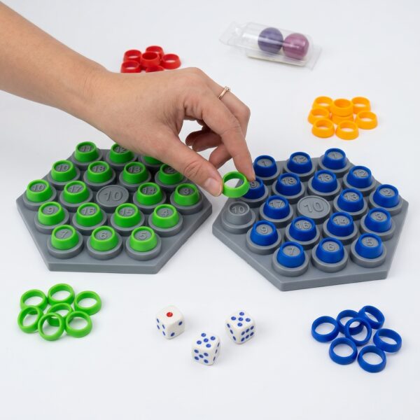 Four children laughing and playing the KidNzo Rapid Calculation math board game, using dice and colorful rings on grey numbered boards to solve equations.