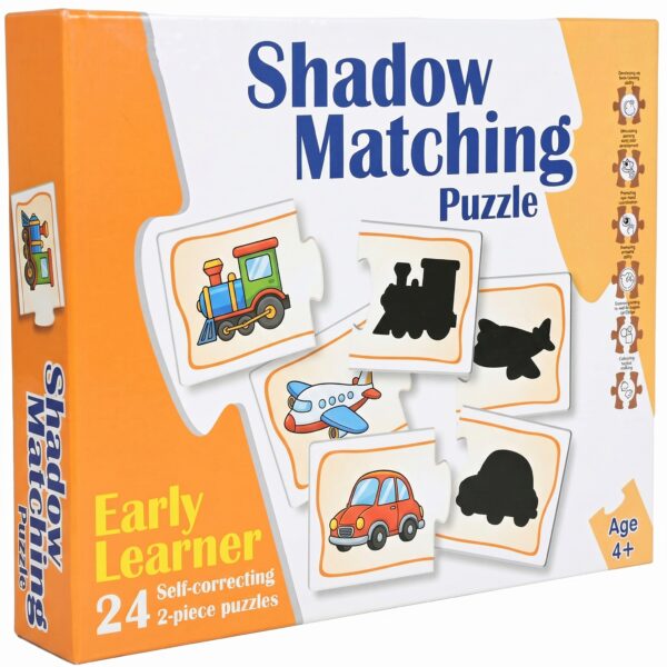 A young boy sitting at a wooden desk, focused on assembling KidNzo Shadow Matching 2-piece puzzles, pairing colorful objects like a frog and helicopter to their silhouettes.