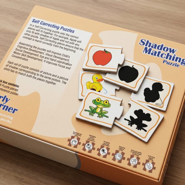 A young boy sitting at a wooden desk, focused on assembling KidNzo Shadow Matching 2-piece puzzles, pairing colorful objects like a frog and helicopter to their silhouettes.